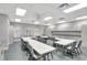 U-shaped tables and chairs in a well-lit community room at 5025 St Andrews Arc, Leesburg, FL 34748