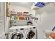 Laundry room with LG washer and dryer, shelving and hanging rod at 5025 St Andrews Arc, Leesburg, FL 34748