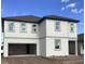 Two-story house with light beige siding, attached garage, and dark brown roof at 5739 Cattle Ranch Dr, Saint Cloud, FL 34771