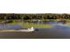 Aerial view of lakefront property with seaplane and dock at 6320 Rocky Point Rd, Lake Wales, FL 33898