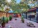 Backyard with a storage shed, covered parking, and decorative plants at 6320 Rocky Point Rd, Lake Wales, FL 33898