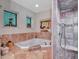Spa-like bathroom with corner jacuzzi tub and walk-in shower at 6320 Rocky Point Rd, Lake Wales, FL 33898
