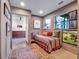 Small bedroom with daybed, artwork, and view of bathroom at 6320 Rocky Point Rd, Lake Wales, FL 33898