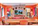 Bright dining area with a long wooden table and colorful chairs at 6320 Rocky Point Rd, Lake Wales, FL 33898
