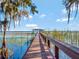 Long wooden dock extending over calm lake waters at 6320 Rocky Point Rd, Lake Wales, FL 33898