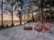 Cozy fire pit area on the sandy lakefront shore with seating and sunset views at 6320 Rocky Point Rd, Lake Wales, FL 33898