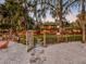 Inviting front yard with a sandy path leading to a charming home at sunset at 6320 Rocky Point Rd, Lake Wales, FL 33898