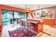 Stylish kitchen with orange cabinets, an island, and a view of the backyard at 6320 Rocky Point Rd, Lake Wales, FL 33898