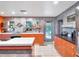 Modern kitchen with orange cabinets, unique backsplash, and a center island at 6320 Rocky Point Rd, Lake Wales, FL 33898