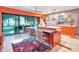 Stylish kitchen with orange cabinets, an island, and a view of the backyard at 6320 Rocky Point Rd, Lake Wales, FL 33898