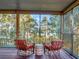 Screened porch with wicker chairs and a water view at 6320 Rocky Point Rd, Lake Wales, FL 33898