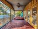 Spacious screened porch with a wooden daybed at 6320 Rocky Point Rd, Lake Wales, FL 33898