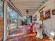 Cozy screened porch with wicker seating and red pillows at 6320 Rocky Point Rd, Lake Wales, FL 33898