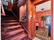 Elegant staircase with rich red carpeting leading to another level at 6320 Rocky Point Rd, Lake Wales, FL 33898