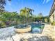 Relaxing pool and spa area with patio and lush landscaping at 6326 Swanson St, Windermere, FL 34786