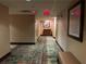 Hotel hallway with carpet, seating, and artwork at 7601 Canada Ave # 221, Orlando, FL 32819