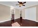 Spacious bedroom with hardwood floors, ceiling fan, and ensuite bathroom access at 846 Riggs Cir, Davenport, FL 33897