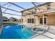 Inviting screened pool and spa with home view at 846 Riggs Cir, Davenport, FL 33897