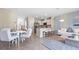 Open concept dining area with white table and chairs at 1218 Balsam Dr, Davenport, FL 33837
