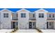 Three-unit townhome building, featuring attached garages and modern design at 1218 Balsam Dr, Davenport, FL 33837