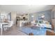 Open living area with light and airy feel, featuring a comfy sofa and large windows at 1218 Balsam Dr, Davenport, FL 33837