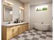 Modern bathroom with double vanity, freestanding tub, and black and white checkered floor at 1309 Errol Green Ct, Apopka, FL 32712