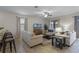 Spacious living room with neutral colored sofas and large TV at 1429 Moon Valley Dr, Champions Gate, FL 33896