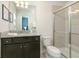Contemporary bathroom with a walk-in shower, dark wood vanity, and a toilet at 1671 Kona Ln, Davenport, FL 33897