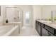 Spacious bathroom with a walk-in shower, soaking tub, and double vanity at 1671 Kona Ln, Davenport, FL 33897