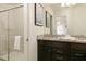 Modern bathroom with a granite countertop, dual sink vanity, and a frameless glass shower at 1671 Kona Ln, Davenport, FL 33897