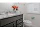Bathroom featuring granite countertop, dark wood cabinets, and simple decor at 1671 Kona Ln, Davenport, FL 33897