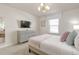 Cozy bedroom with a comfortable bed, dresser, and a wall-mounted television at 1671 Kona Ln, Davenport, FL 33897