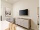 Stylish bedroom with a comfortable bed, an armchair, and a wall-mounted TV at 1671 Kona Ln, Davenport, FL 33897