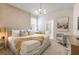 Elegant bedroom with a plush bed, a sitting area, and access to an ensuite bathroom at 1671 Kona Ln, Davenport, FL 33897