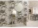 Entryway with a stylish round mirror, console table, and tropical-themed wallpaper at 1671 Kona Ln, Davenport, FL 33897