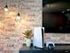 Entertainment area with a PS5, TV, and exposed brick wall at 1671 Kona Ln, Davenport, FL 33897