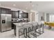 Modern kitchen with stainless steel appliances, dark cabinets, and a granite countertop at 1671 Kona Ln, Davenport, FL 33897