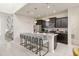 Stylish kitchen featuring an island with bar seating, dark cabinetry, and stainless steel appliances at 1671 Kona Ln, Davenport, FL 33897