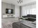 Modern living room with leather furniture, a large TV, and stylish decor at 1671 Kona Ln, Davenport, FL 33897