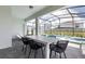 Screened-in patio with dining table, pool, and spa at 1671 Kona Ln, Davenport, FL 33897