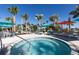 Community spa with lounge chairs and umbrellas at 1671 Kona Ln, Davenport, FL 33897