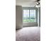 Bedroom with neutral carpeting and large windows at 2015 Erving Cir # 108, Ocoee, FL 34761