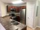 Modern kitchen with stainless steel appliances and dark wood cabinets at 2015 Erving Cir # 108, Ocoee, FL 34761