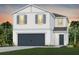 Two-story house with a gray-blue door and dark gray garage door at 3022 Norcott Dr, Davenport, FL 33837