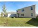 Spacious backyard of a two-story home with green lawn at 328 Conway Ave, Saint Cloud, FL 34771