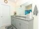 Bathroom with dual sinks, gray vanity, and a large mirror at 328 Conway Ave, Saint Cloud, FL 34771