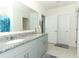 Modern bathroom with double sinks, granite countertop, and gray cabinets at 328 Conway Ave, Saint Cloud, FL 34771