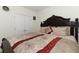 Bedroom with carpet, a dark wood bedframe, and white double doors to a closet at 328 Conway Ave, Saint Cloud, FL 34771
