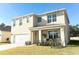 Charming two-story home with a covered porch, attached garage, and landscaped yard at 328 Conway Ave, Saint Cloud, FL 34771