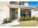 Covered front porch with seating area, grill, and lush landscaping at 328 Conway Ave, Saint Cloud, FL 34771